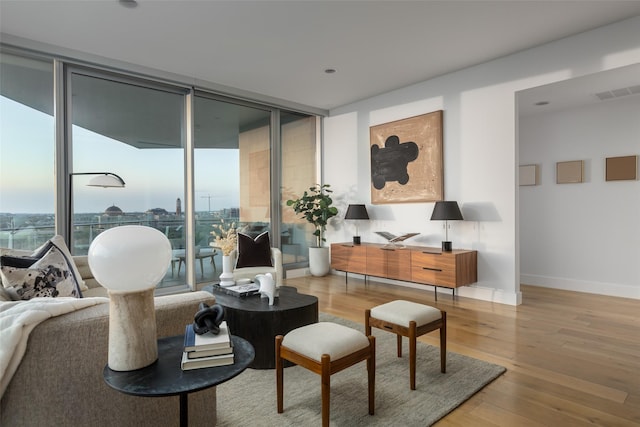 3130 N Harwood St Unit 903, Dallas, TX 75201 - living room featuring light wood-type flooring, baseboards, and a wall of windows