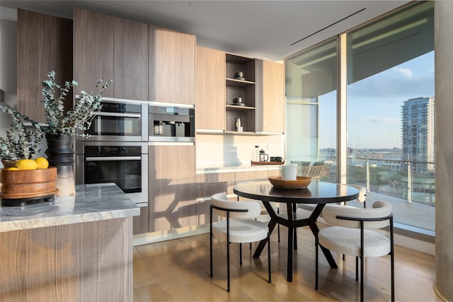 3130 N Harwood St Unit 903, Dallas, TX 75201 - dining area with wood finished floors and floor to ceiling windows