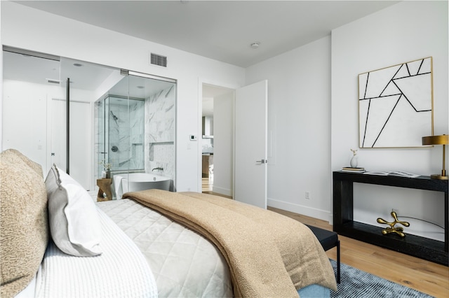 3130 N Harwood St Unit 903, Dallas, TX 75201 - bedroom with wood finished floors and baseboards
