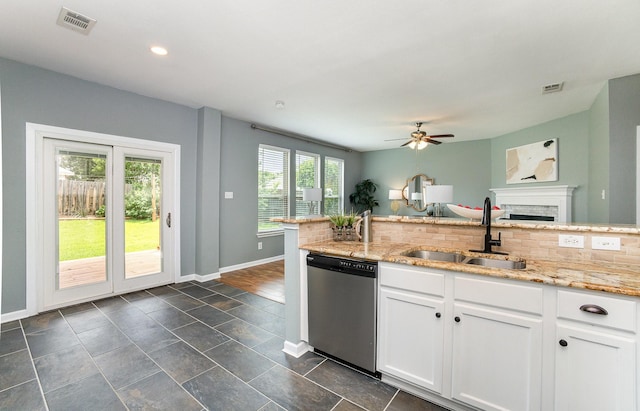 9305 Manassas Rdg, Mckinney, TX 75071 - kitchen featuring stainless steel dishwasher, a sink, decorative backsplash, baseboards, and a ceiling fan