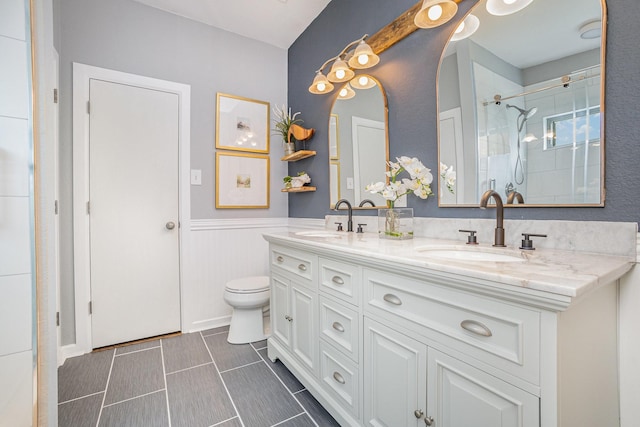 9305 Manassas Rdg, Mckinney, TX 75071 - full bath featuring wainscoting, double vanity, a shower, and toilet