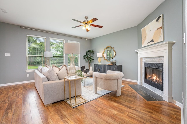 9305 Manassas Rdg, Mckinney, TX 75071 - living room with a fireplace, ceiling fan, wood-type flooring, and baseboards