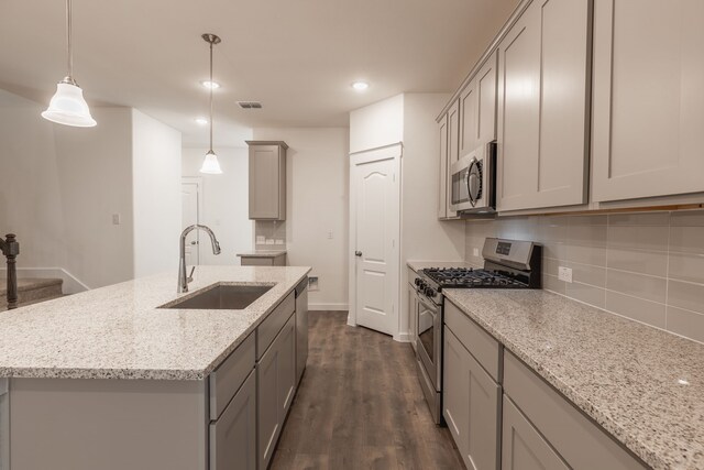 2506 Sun Grove Rd, Melissa, TX 75454 - kitchen featuring stainless steel appliances, a sink, gray cabinets, tasteful backsplash, and dark wood-style floors