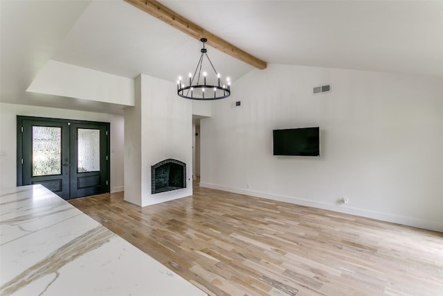 203 Oak Valley Dr, Colleyville, TX 76034 - unfurnished living room featuring french doors, light wood-style floors, a chandelier, a fireplace, and baseboards