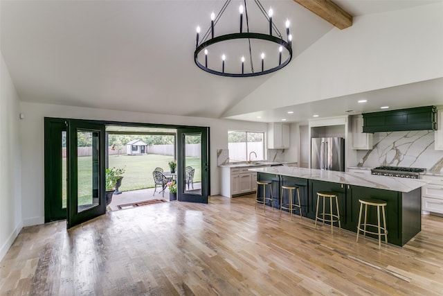203 Oak Valley Dr, Colleyville, TX 76034 - kitchen featuring high quality fridge, beam ceiling, a breakfast bar, a spacious island, and white cabinetry