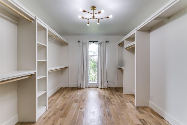 203 Oak Valley Dr, Colleyville, TX 76034 - walk in closet with a chandelier and light wood-style flooring