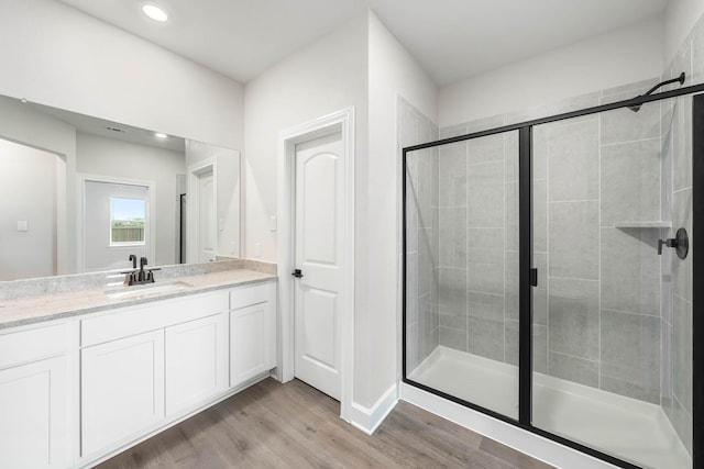 1005 Pecan Pl, Hutchins, TX 75141 - bathroom featuring a shower stall, wood finished floors, vanity, and recessed lighting