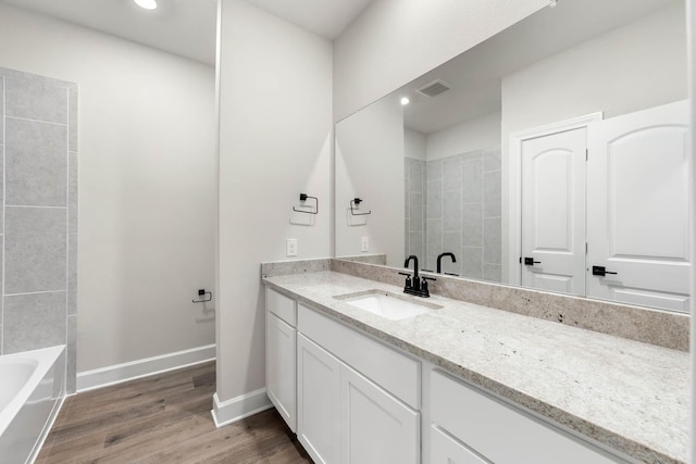 1005 Pecan Pl, Hutchins, TX 75141 - bathroom featuring wood finished floors, vanity, baseboards, and recessed lighting