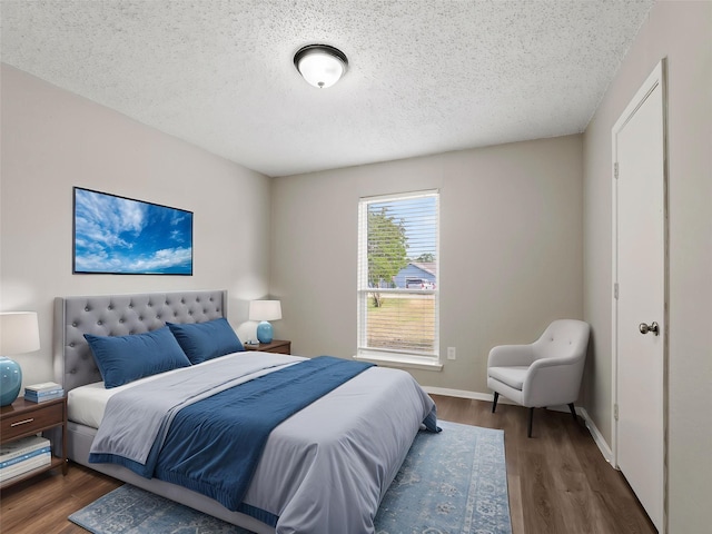638 Matador Dr, Little Elm, TX 75068 - bedroom with wood finished floors, a textured ceiling, and baseboards