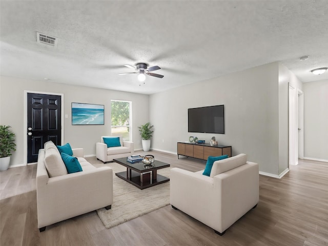638 Matador Dr, Little Elm, TX 75068 - living room with a textured ceiling, wood finished floors, ceiling fan, and baseboards