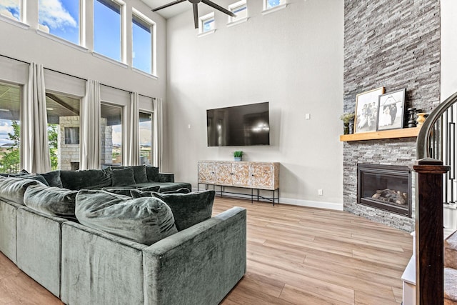 3204 Creek Meadow Dr, Anna, TX 75409 - living room with a towering ceiling, a ceiling fan, a fireplace, wood finished floors, and baseboards