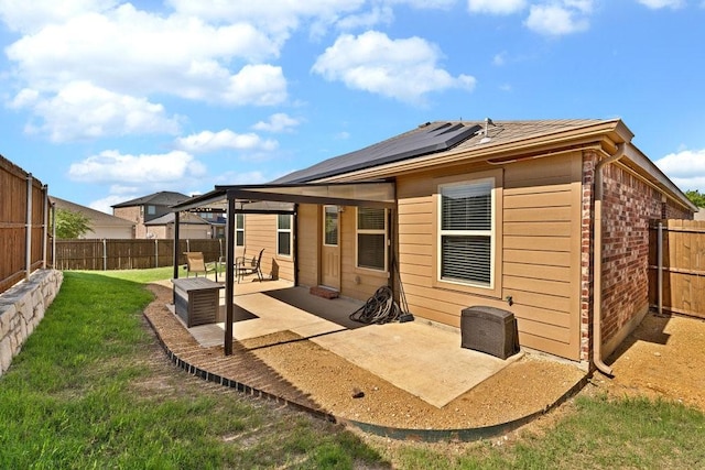 1302 Copper St, Princeton, TX 75407 - rear view of house with solar panels and a patio area