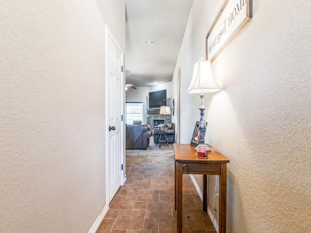 2103 Ridgewood Dr, Bridgeport, TX 76426 - hallway with stone finish flooring, baseboards, and a textured wall