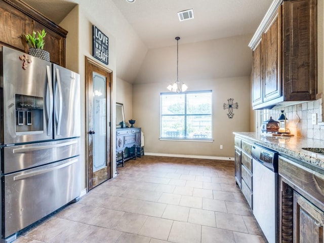 2103 Ridgewood Dr, Bridgeport, TX 76426 - kitchen with stainless steel appliances, light stone countertops, baseboards, vaulted ceiling, and backsplash