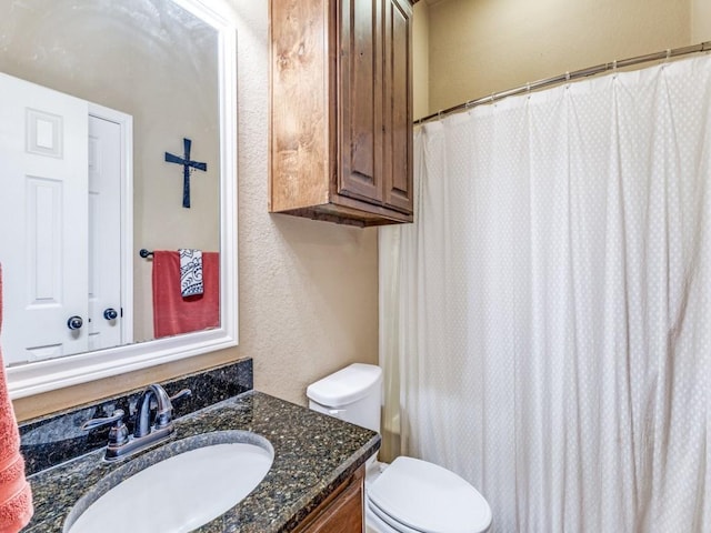 2103 Ridgewood Dr, Bridgeport, TX 76426 - full bath with a textured wall, toilet, vanity, and a shower with shower curtain
