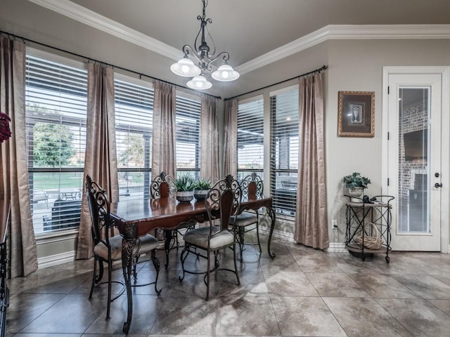 1650 Winding Creek Ln, Rockwall, TX 75032 - dining room featuring crown molding, baseboards, healthy amount of natural light, and a chandelier