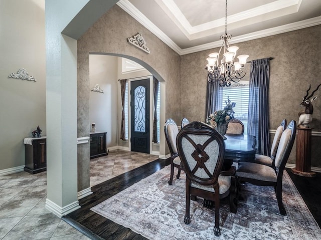 1650 Winding Creek Ln, Rockwall, TX 75032 - dining space featuring arched walkways, a chandelier, ornamental molding, a raised ceiling, and baseboards