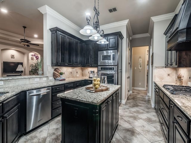 1650 Winding Creek Ln, Rockwall, TX 75032 - kitchen with stainless steel appliances, custom range hood, backsplash, dark cabinets, and ceiling fan