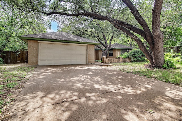 6109 Rayburn Ct, Fort Worth, TX 76133 - view of front of home with brick siding, concrete driveway, and an outbuilding