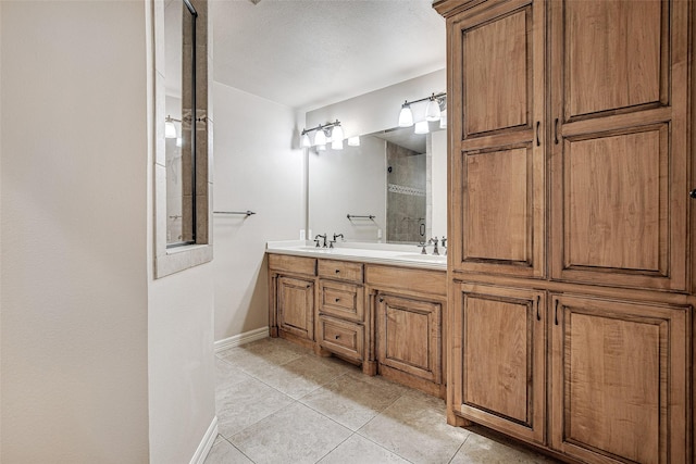 6109 Rayburn Ct, Fort Worth, TX 76133 - bathroom with tile patterned floors, a tile shower, baseboards, and double vanity