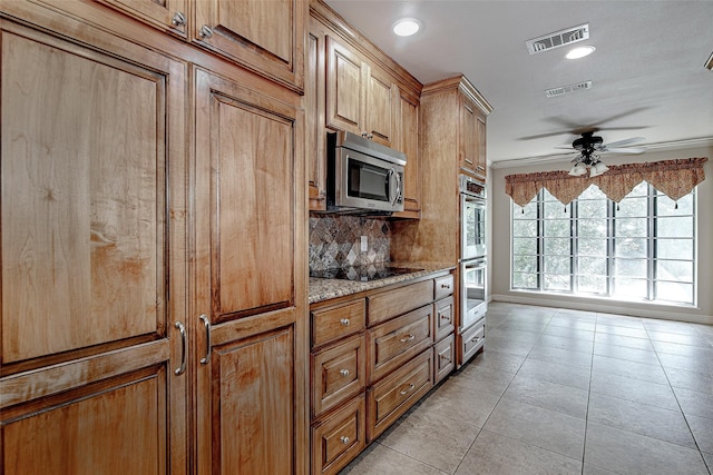 6109 Rayburn Ct, Fort Worth, TX 76133 - kitchen featuring appliances with stainless steel finishes, light tile patterned flooring, a ceiling fan, light stone counters, and backsplash