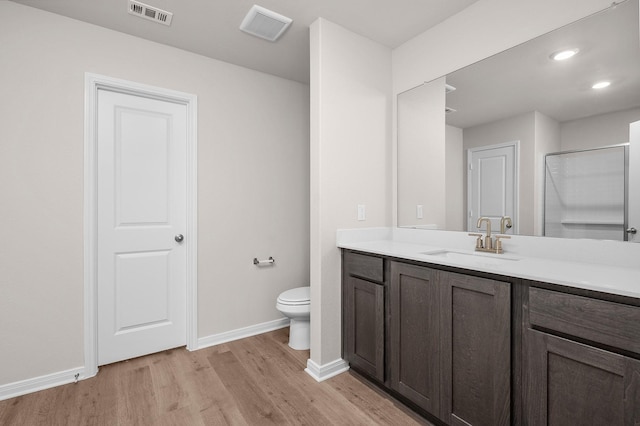221 Southgate Dr, Terrell, TX 75160 - full bathroom with wood finished floors, vanity, baseboards, toilet, and a shower