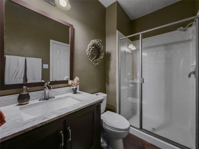 4305 Diplomacy Dr, Rowlett, TX 75089 - full bathroom with a shower stall, vanity, toilet, and a textured wall