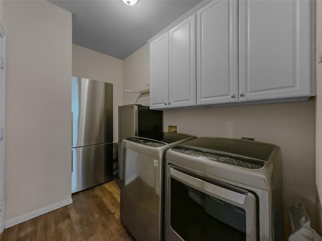 4305 Diplomacy Dr, Rowlett, TX 75089 - clothes washing area featuring cabinet space, washer and clothes dryer, dark wood-type flooring, and baseboards