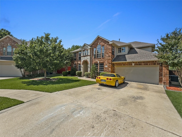 4305 Diplomacy Dr, Rowlett, TX 75089 - view of front of property with brick siding, a front lawn, concrete driveway, a shingled roof, and an attached garage