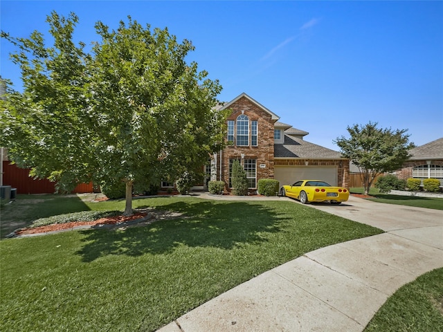 4305 Diplomacy Dr, Rowlett, TX 75089 - view of front facade featuring brick siding, concrete driveway, a front yard, and an attached garage