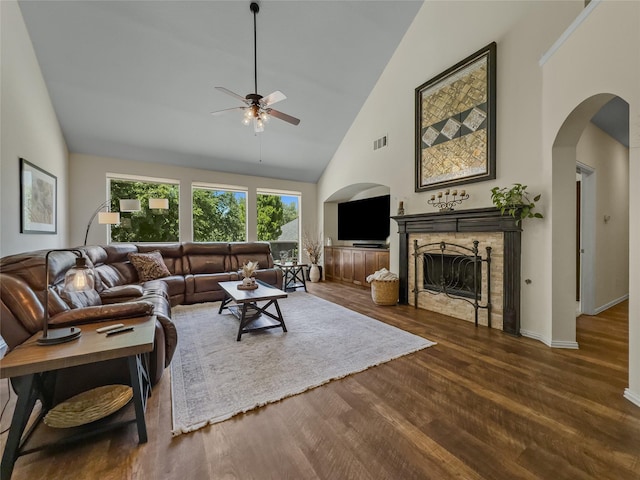 4305 Diplomacy Dr, Rowlett, TX 75089 - living area featuring ceiling fan, high vaulted ceiling, wood finished floors, arched walkways, and a fireplace