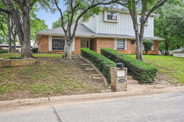 4705 Woodview St, Arlington, TX 76013 - view of front of house with brick siding and board and batten siding
