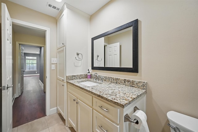 4705 Woodview St, Arlington, TX 76013 - bathroom with toilet, vanity, baseboards, and tile patterned floors