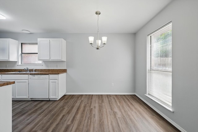 7710 Sable Ln, North Richland Hills, TX 76182 - kitchen featuring white dishwasher, dark countertops, white cabinets, dark wood-style floors, and healthy amount of natural light