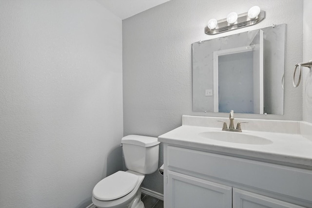 7710 Sable Ln, North Richland Hills, TX 76182 - bathroom with vanity, toilet, and baseboards