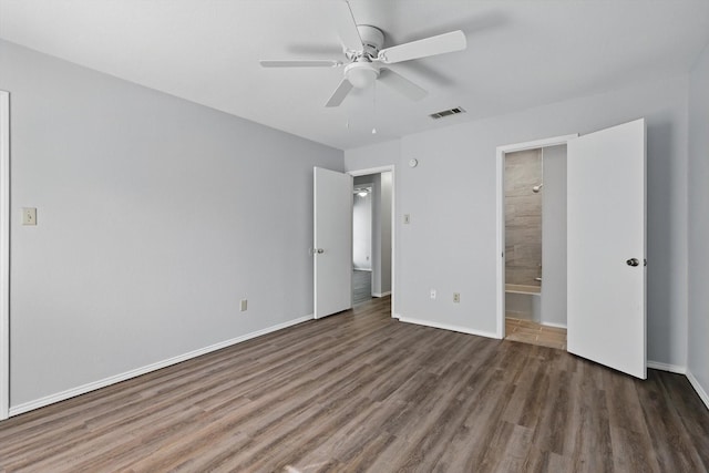 7710 Sable Ln, North Richland Hills, TX 76182 - unfurnished bedroom with wood finished floors, baseboards, ensuite bath, and ceiling fan