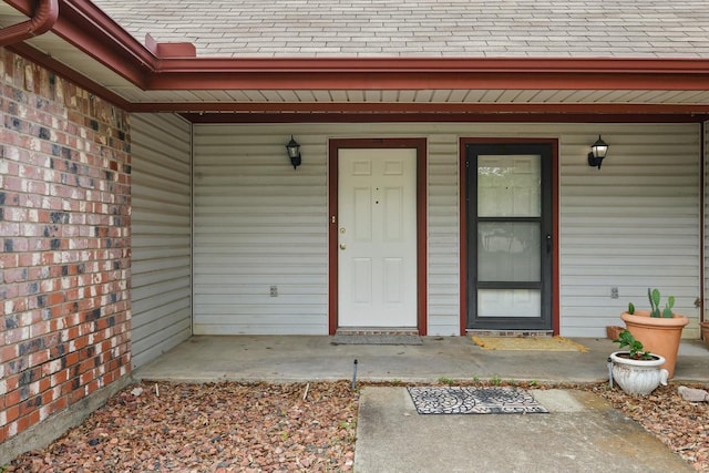 7710 Sable Ln, North Richland Hills, TX 76182 - doorway to property featuring a shingled roof and covered porch