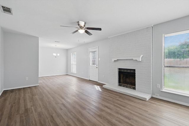7710 Sable Ln, North Richland Hills, TX 76182 - unfurnished living room with a ceiling fan, a fireplace, wood finished floors, and baseboards