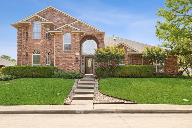 1086 Whispering Gln, Rockwall, TX 75087 - traditional-style home featuring a front lawn and brick siding