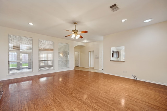 1086 Whispering Gln, Rockwall, TX 75087 - unfurnished living room with ceiling fan, baseboards, wood finished floors, and recessed lighting