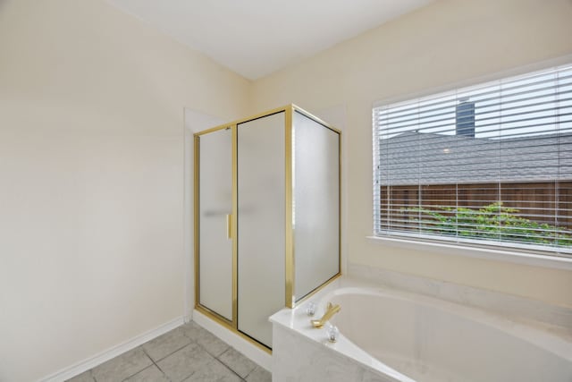 1086 Whispering Gln, Rockwall, TX 75087 - bathroom featuring plenty of natural light, a shower stall, tile patterned flooring, and a bath