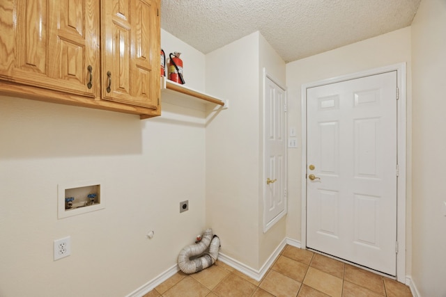 1086 Whispering Gln, Rockwall, TX 75087 - laundry area with hookup for an electric dryer, baseboards, light tile patterned floors, washer hookup, and a textured ceiling