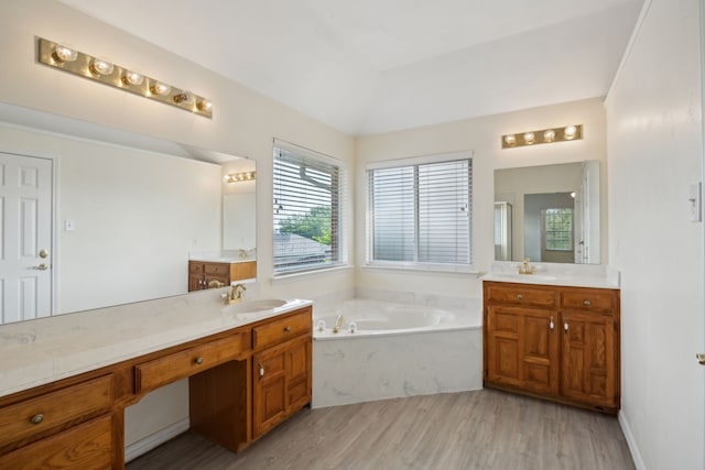 1086 Whispering Gln, Rockwall, TX 75087 - bathroom with wood finished floors, a garden tub, and two vanities