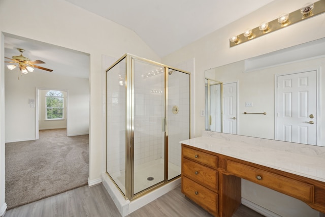 1086 Whispering Gln, Rockwall, TX 75087 - full bath featuring a shower stall, ceiling fan, vaulted ceiling, vanity, and wood finished floors