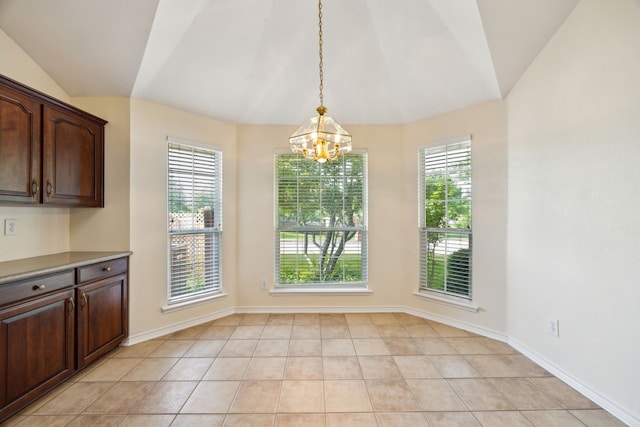 1086 Whispering Gln, Rockwall, TX 75087 - unfurnished dining area with vaulted ceiling, a chandelier, light tile patterned floors, and baseboards