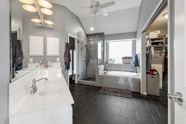 full bath with a shower stall, a garden tub, vaulted ceiling, a walk in closet, and double vanity