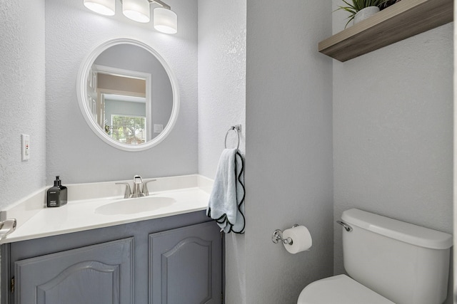 bathroom with toilet and vanity