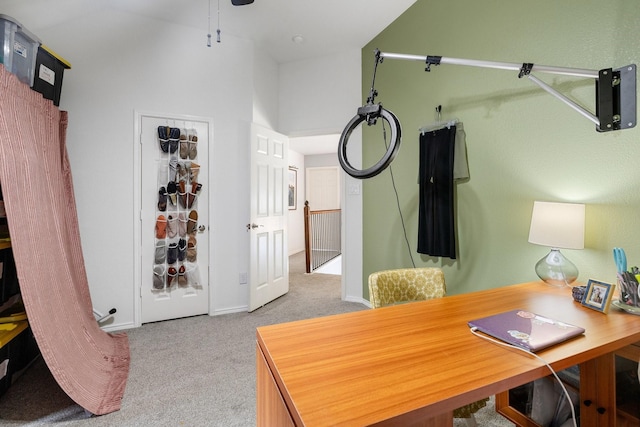 carpeted home office featuring a ceiling fan and baseboards