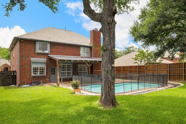 back of house with a chimney, brick siding, and a patio