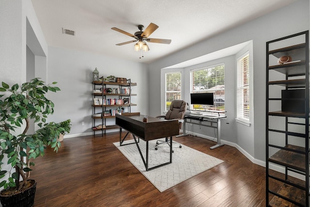 office area featuring dark wood-style floors, ceiling fan, and baseboards